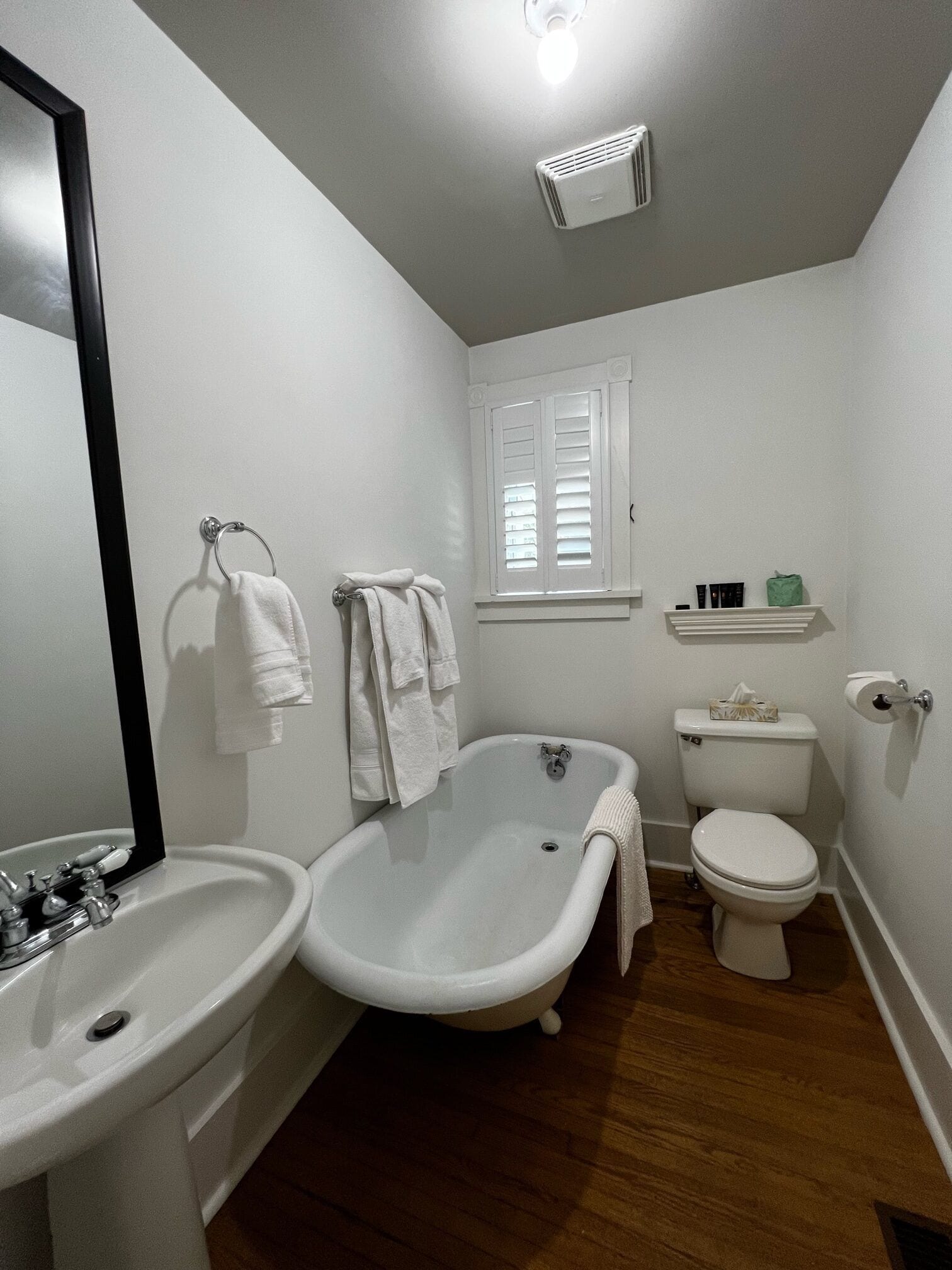 A bathroom with a bathtub, toilet, and sink.