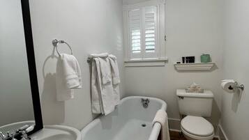A bathroom with a bathtub, toilet, and sink.