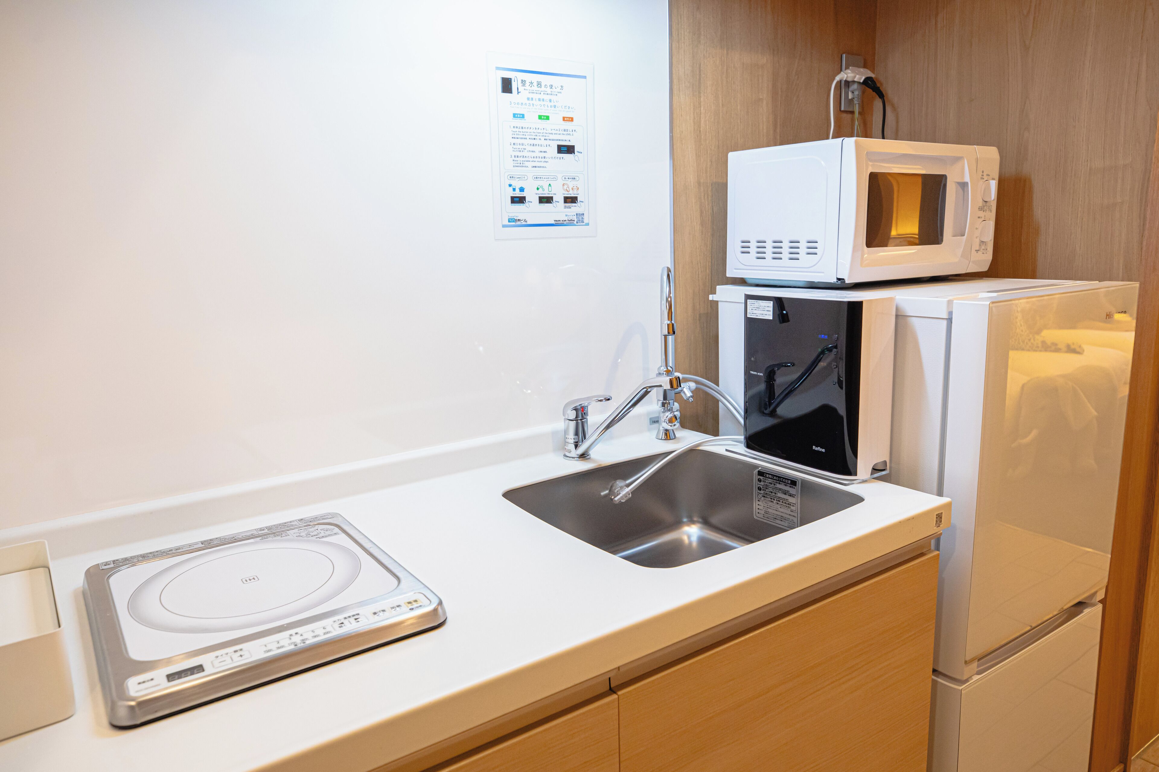 A kitchenette with a microwave, a toaster, and a sink.