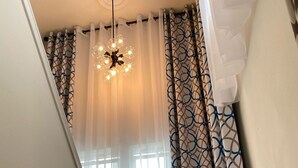 A staircase with a wooden handrail, white walls, and a ceiling light fixture. - Lynnwood Airport-Retreat (Lynnwood)