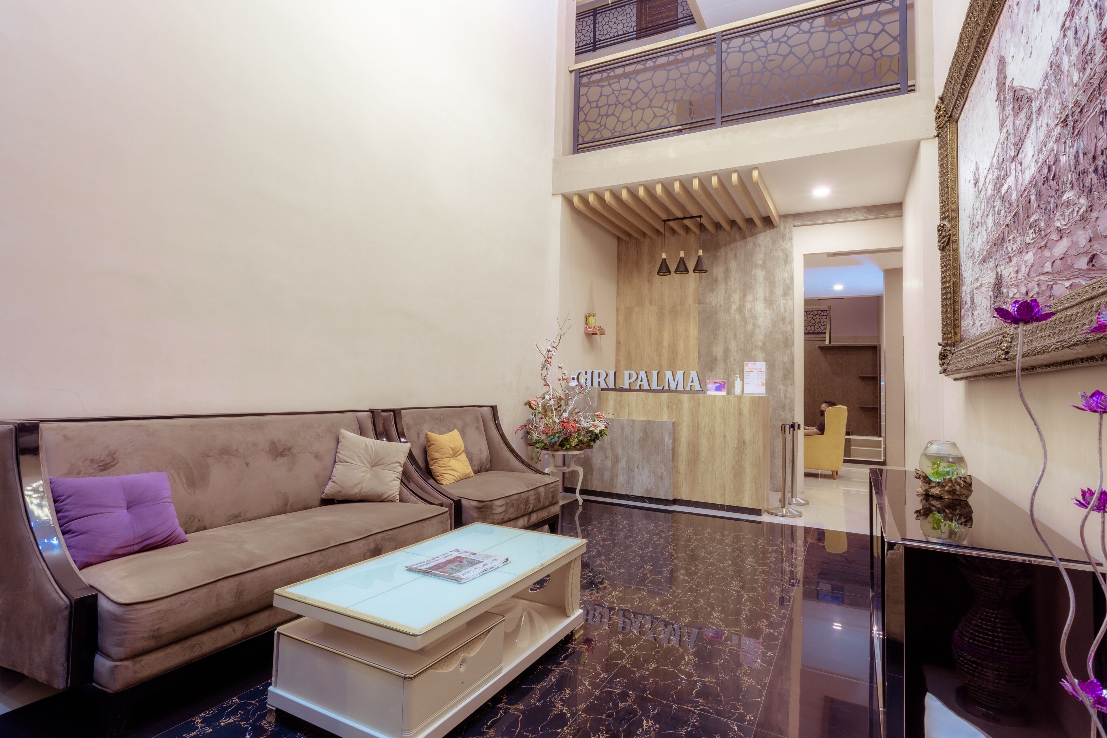 A spacious lobby with a modern sofa, a coffee table, and a reception desk.