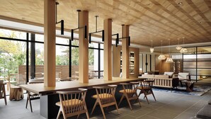 A modern bar area with wooden furniture and pendant lighting.