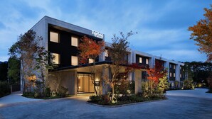 A modern hotel with a large entrance, a sign reading "Fairfield by Marriott," and a well-lit exterior.