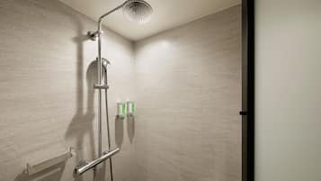 A modern shower with a handheld showerhead, a wall-mounted control panel, and a towel rack.