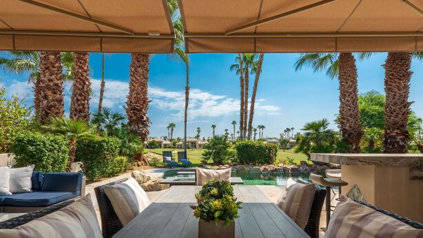 An outdoor patio with a pool, lounge chairs, and a view of a golf course. - Gorgeous Home w/Saltwater Pool/Spa with MISTERS! PGA West - Fabulous Outdoor Setting-3BD#245594 (La Quinta)