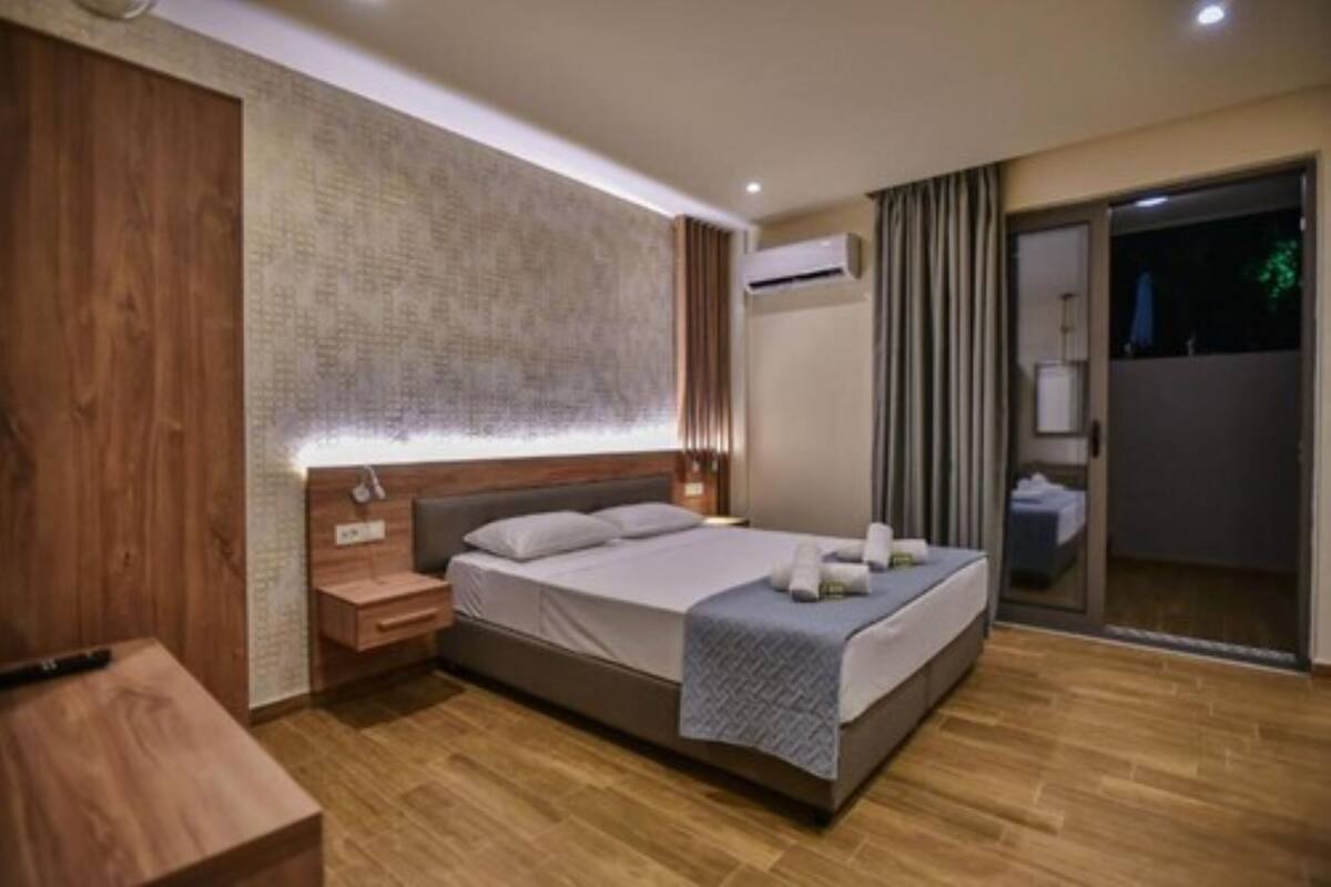 A modern bedroom with a wooden headboard, a bedside table, and a large bed.