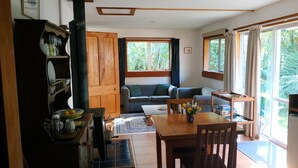 A compact living space with a dining area, a sofa, and a kitchen counter. - A comfortable, private, country apartment. 300mts walk to safe sandy beach. (Collingwood)