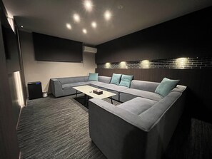 Un soggiorno moderno con un divano componibile, un tavolino da caffè e illuminazione a soffitto a incasso.