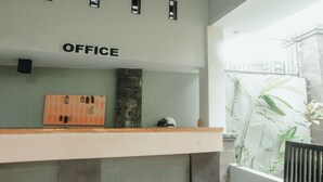 An office area with a reception desk, a bulletin board, and a sign that reads "OFFICE". - Hotel Diana 2 (Denpasar)