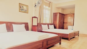 Two wooden beds with white linens, a wooden wardrobe, a mirror, and a window with curtains. - Cuc Phuong Hotel (Ho Chi Minh City)
