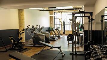 A gym with exercise equipment, including treadmills, stationary bikes, and weight machines.
