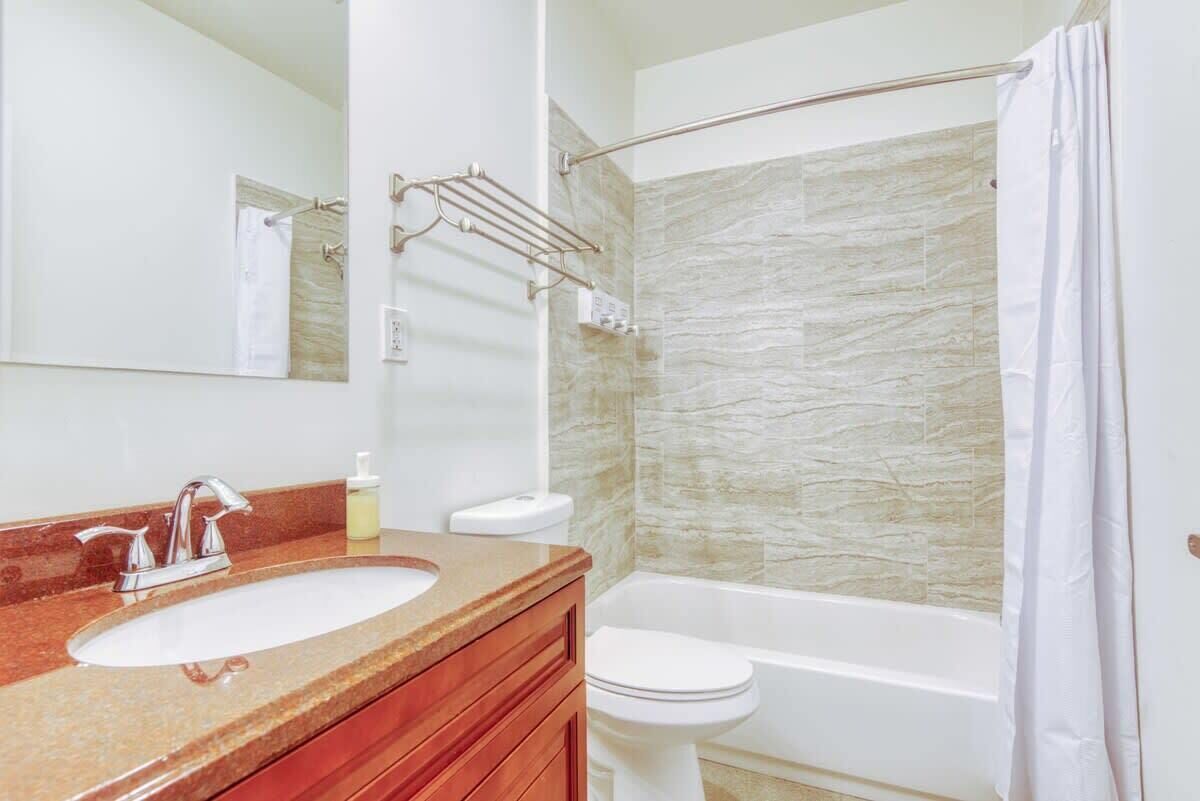 A bathroom with a sink, toilet, and bathtub.