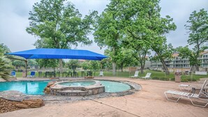 A swimming pool with a hot tub, surrounded by lounge chairs and a blue canopy. - Dreams And Streams Ww H303 3 Bedroom Condo by RedAwning (New Braunfels)