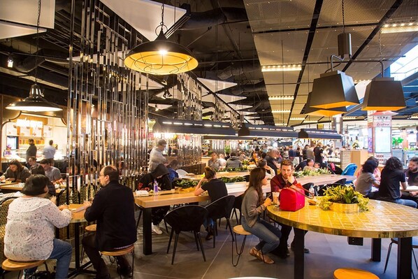 Guests can dine and socialize in this communal space with multiple tables and chairs.