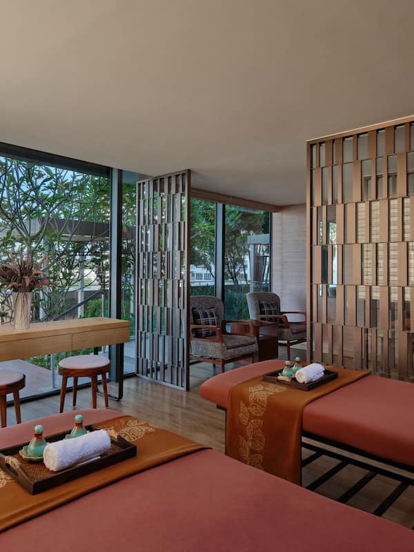Relax in a serene spa room with an outdoor area and stunning views of the surrounding landscape.