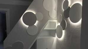 A modern staircase with circular light fixtures and a minimalist design. - Casa Bolle (Sicilia)