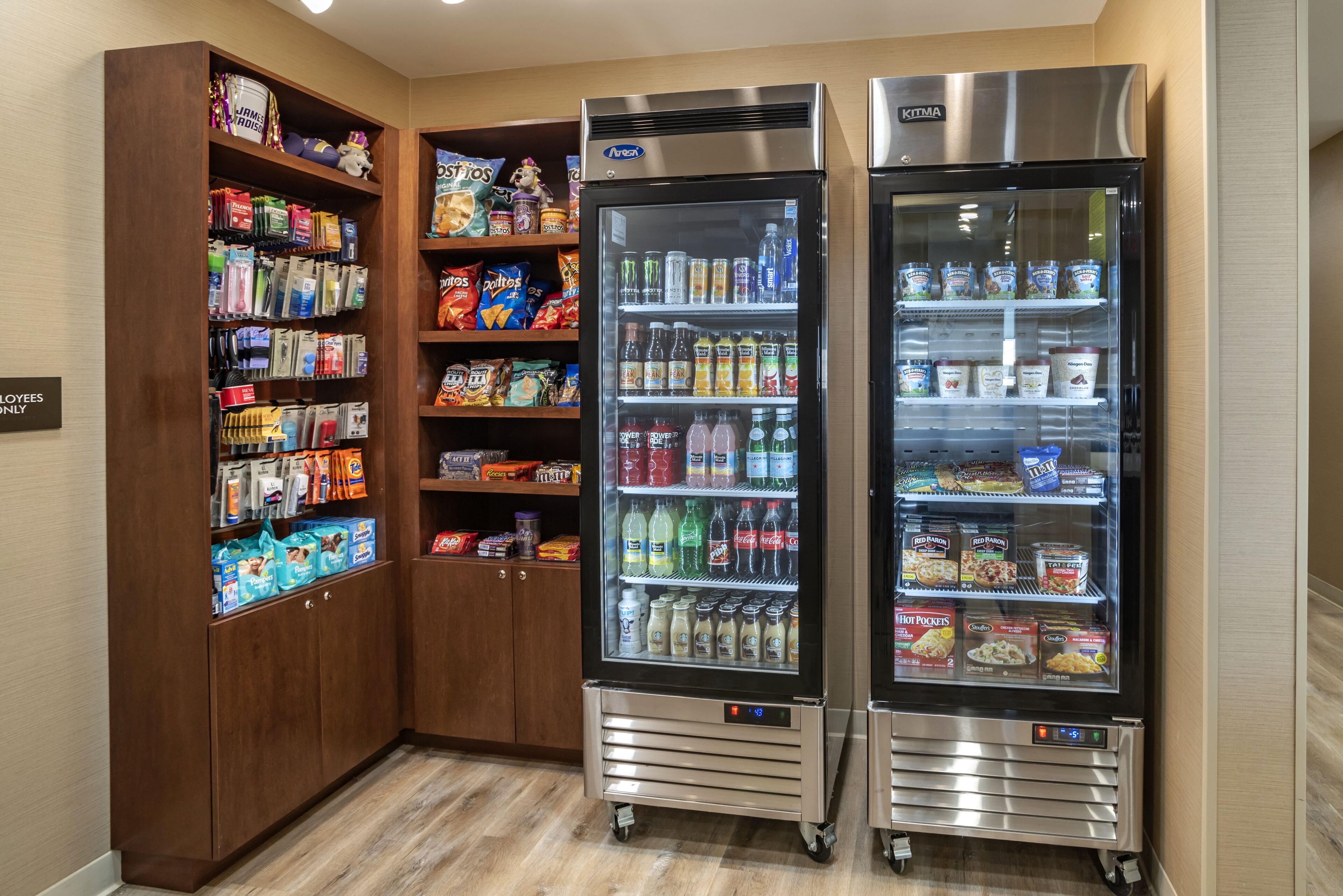 A self-service beverage station with refrigerated drink dispensers and snack shelves.