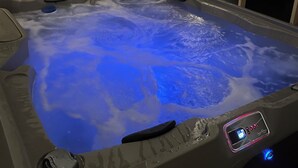 A hot tub with a digital control panel, surrounded by wooden paneling. - ROUGH RIVER LAKE Hot Tub, Pool, Grill, Fire Pit, Party Garage  (Falls of Rough)