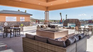 An outdoor lounge area with a pool, seating, and a lifeguard station. - NEW🌟Spacious, Zion Village 7BD/6BA, Sleeps 32, Pool, Lazy River, View  (Hurricane)
