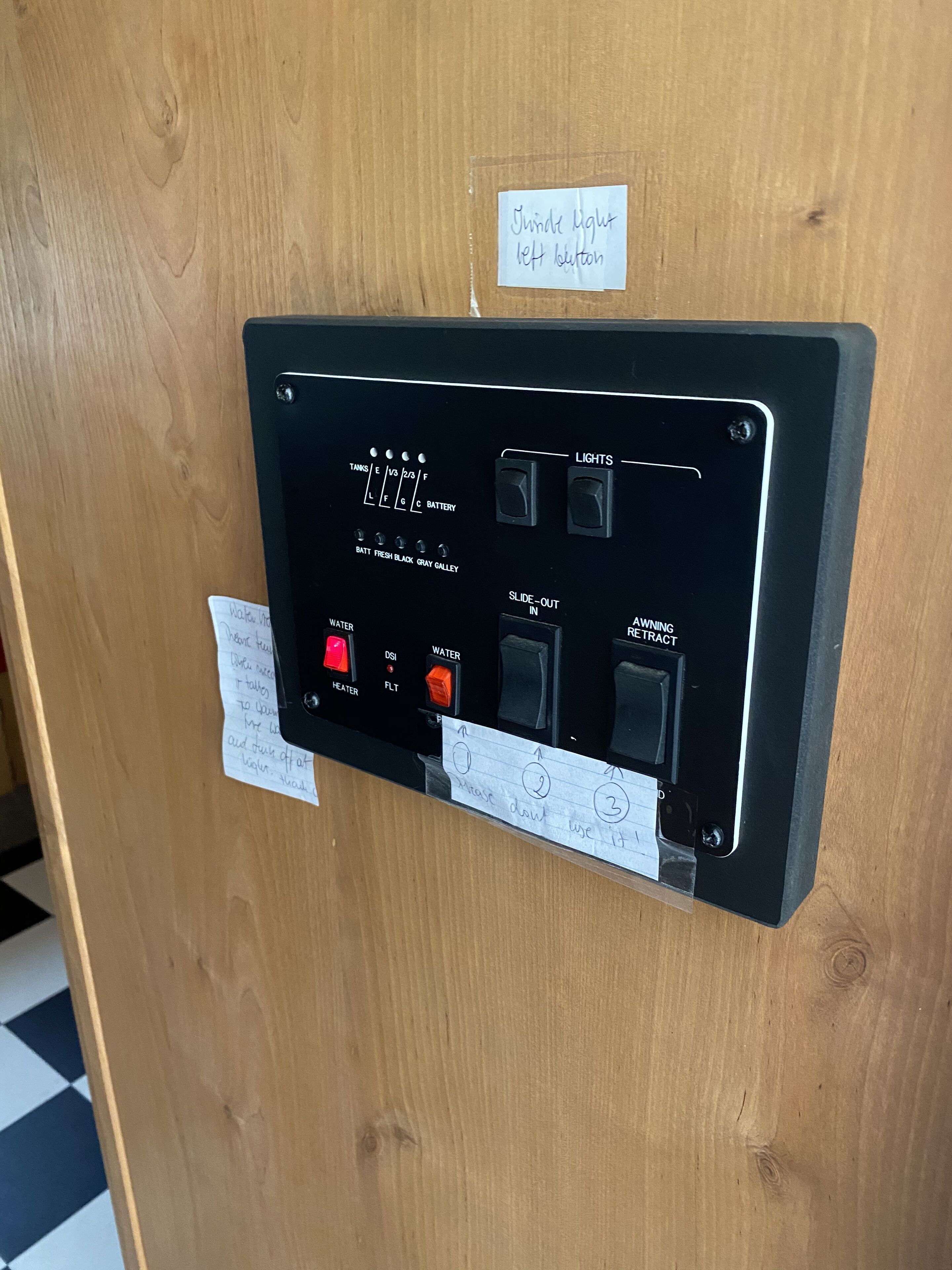 A control panel with various switches and indicators, including lights, water, and battery status.