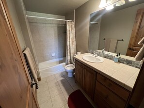 A bathroom with a bathtub, toilet, and sink. - Turnberry Condo (SSL) (Midway)