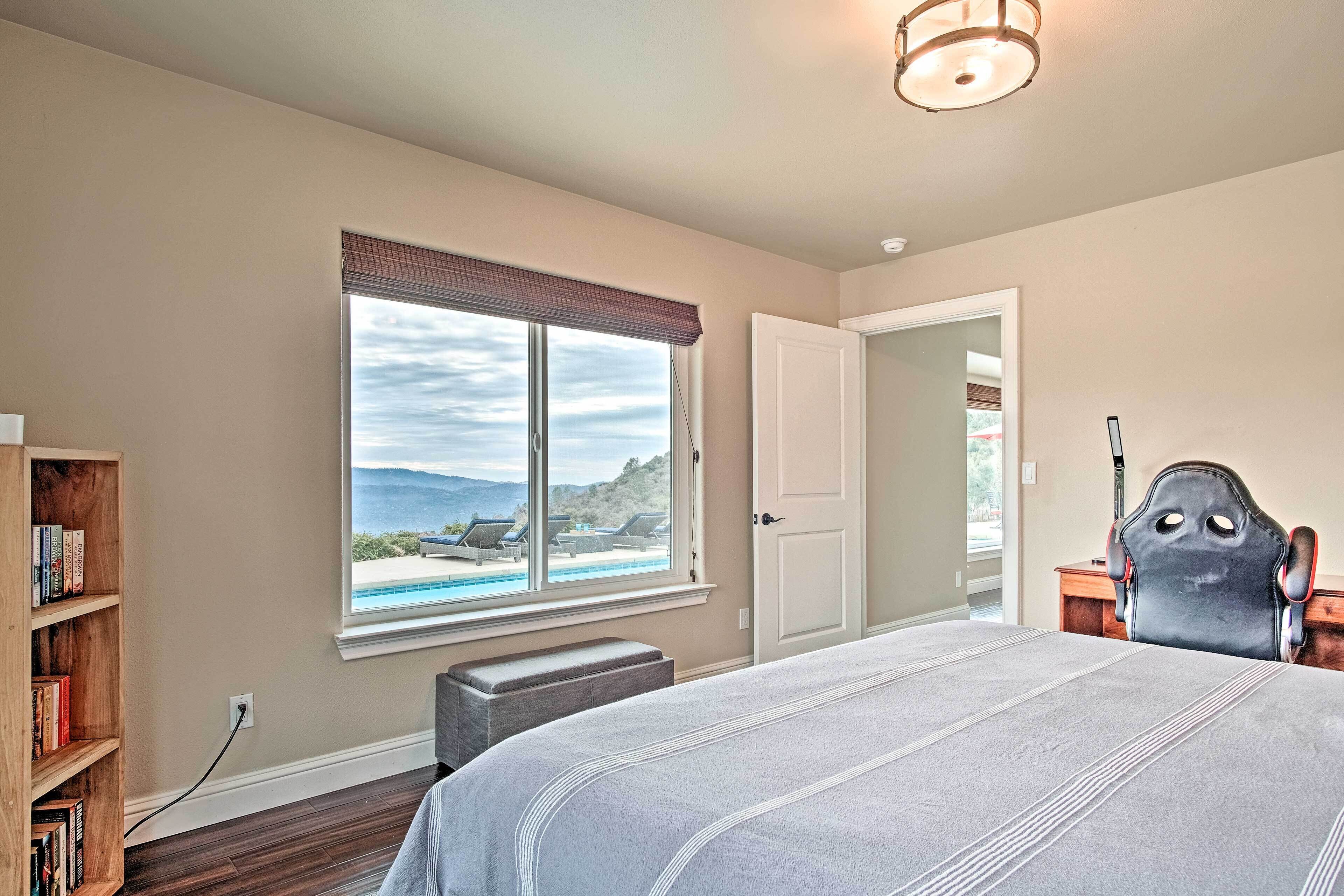 King bedroom with view of backyard and foothills