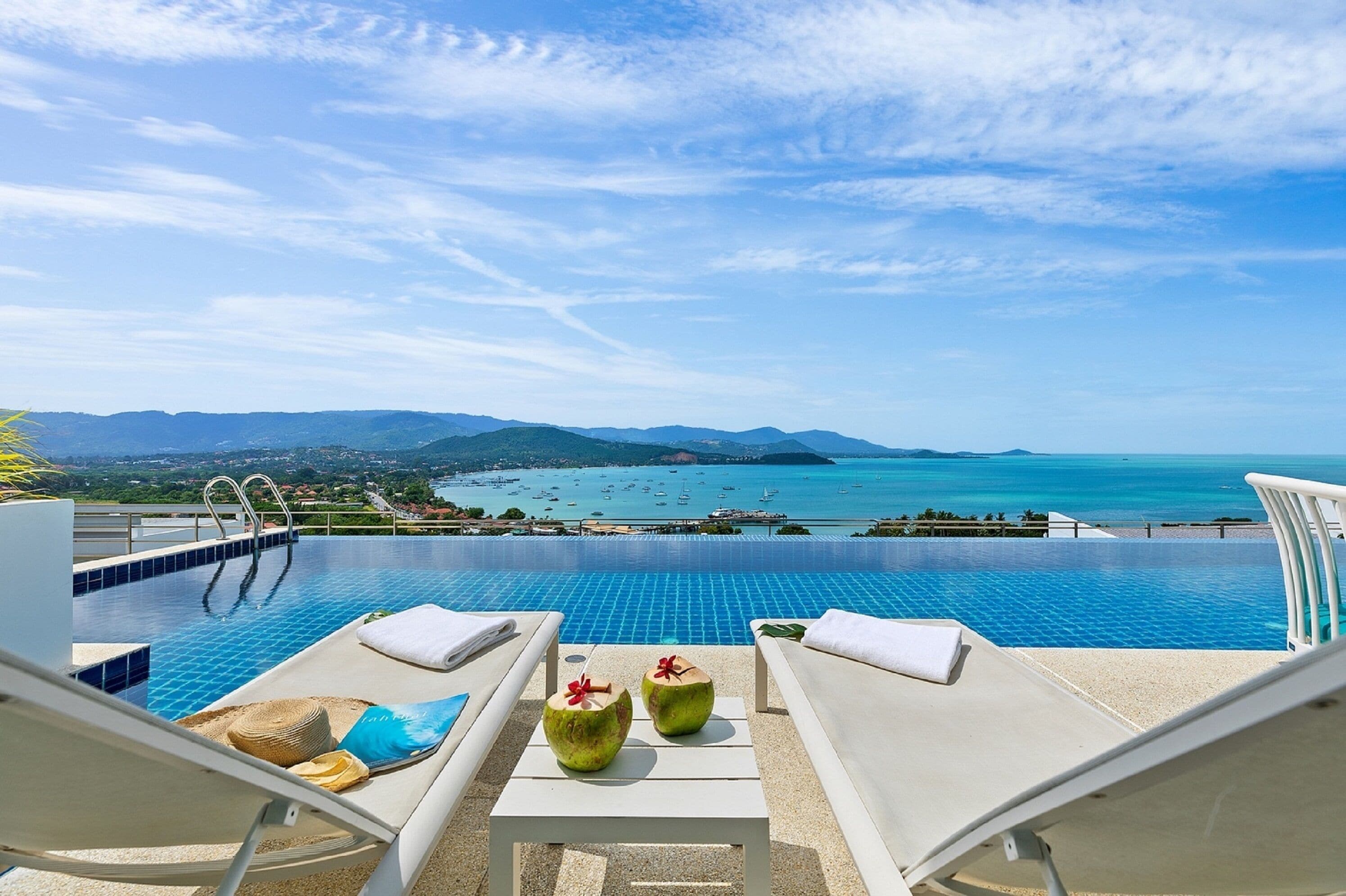 An infinity pool with a view of the sea and mountains.