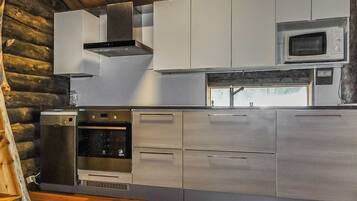 Cozinha moderna com eletrodomésticos de aço inoxidável, incluindo micro-ondas, forno e lava-louças.