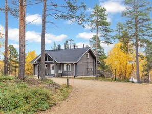 A two-story house with a front porch, a chimney, and a driveway leading to the entrance. - Peurakumpu by Interhome (Inari)