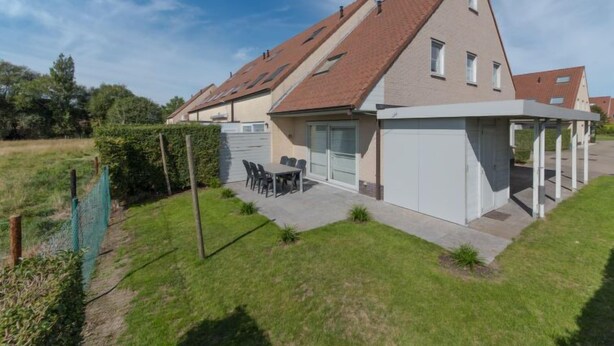 A modern house with a sloped roof, a covered patio, and a garage. - Boonenhove nr.57 with parking by Interhome (De Haan)