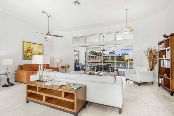 A modern living room with a sofa, coffee table, and a bookshelf.