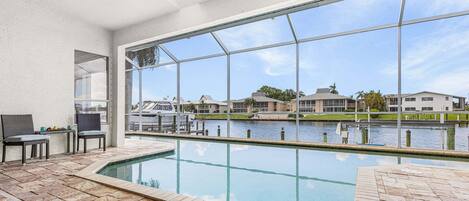 A swimming pool with a view of a marina and buildings.