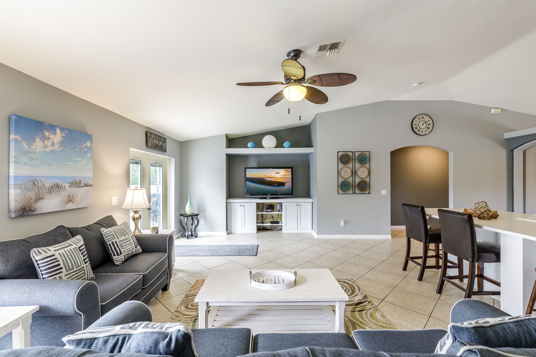 A modern living room with a sofa, coffee table, and TV area.