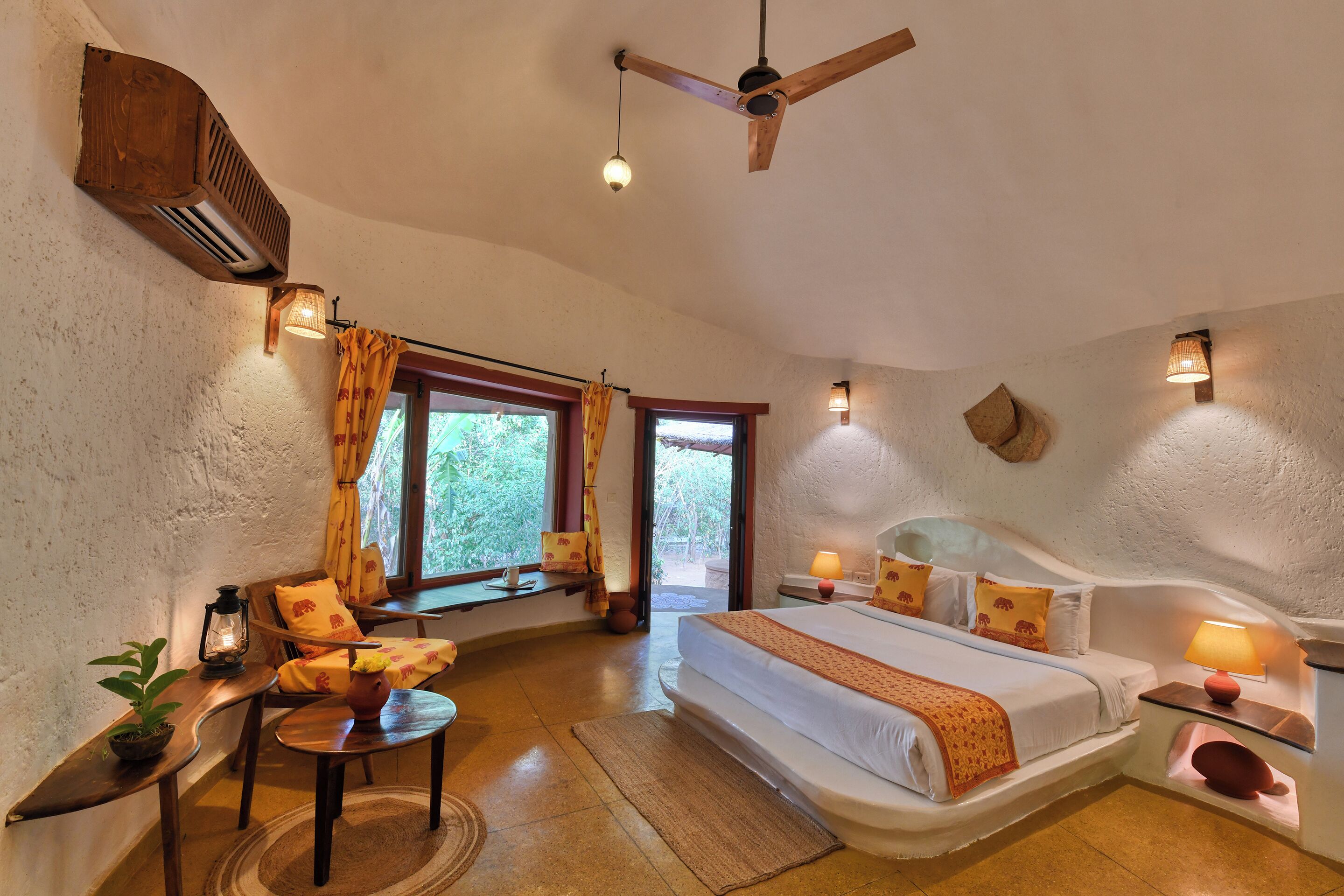 A bedroom with a bed, bedside tables, a chair, a window, and a ceiling fan.