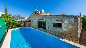 A stone building with a swimming pool, a satellite dish, and a chimney. - Holiday Home ’Casa Paqui Alcudia’ with Wi-Fi, Garden, Terraces & Pool (Puerto de Alcudia)