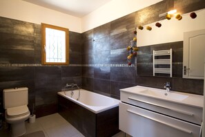 Bathtub, towels, soap, toilet paper