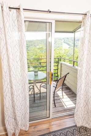 Enjoy dining or relaxing on the balcony with a scenic view of the lush landscape.