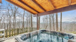 A hot tub with a wooden roof and a view of trees and mountains. - Experience Luxury at The Sanctuary in Hendersonville (Hendersonville)