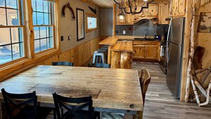 A rustic kitchen with wooden cabinetry, a central island, and a chandelier. - 8 Min to State Parks|Sauna|Fire Pit| (Beaver Bay)