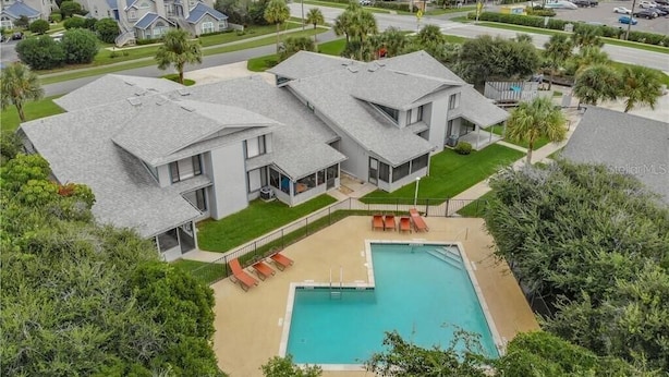 A residential area with modern houses, a swimming pool, and a view of the ocean. - Happy Hours I New Smyrna Poolside at the Beach 2bd/2ba +loft (New Smyrna Beach)