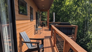 A wooden deck with outdoor furniture, a railing, and a view of trees. - Like New Lake & Mountain Views from every room in the house! (Dandridge)