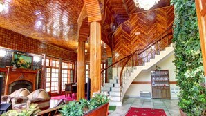A spacious lobby with a wooden ceiling, a staircase, and a red carpet. - Hello we are greeting from royal stay jaisalmer  (jaisalmer india)