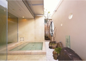 Escape to a serene oasis with a pool and naturalistic garden, perfect for relaxation.