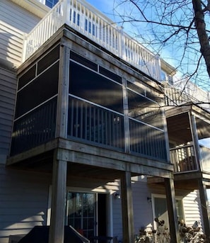 A two-story town home with a balcony and a covered porch area.
