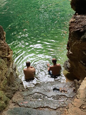 Guests can enjoy serene views of a natural rock formation and a tranquil water body.
