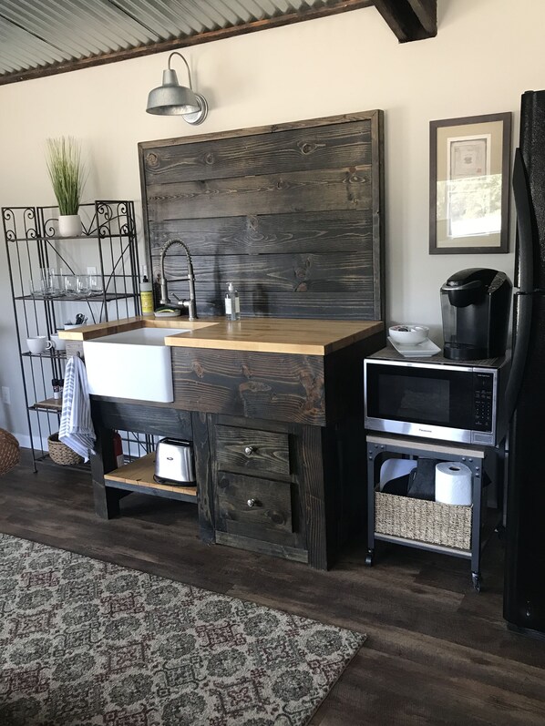 Enjoy cooking in this well-equipped kitchen with a sink, drawers, and a coffee maker.