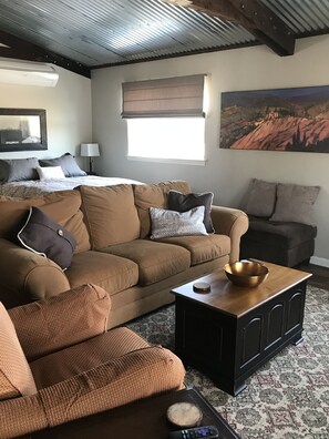 Relax in this inviting living room with a sofa, coffee table, and stunning mountain view.