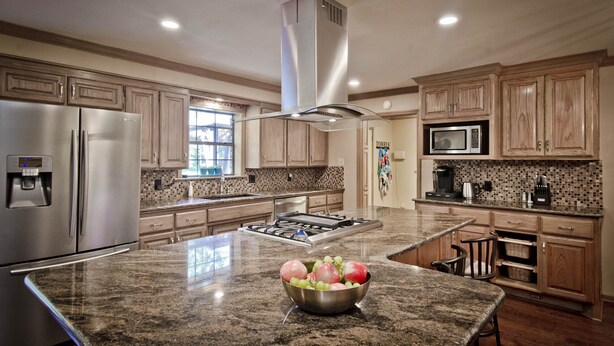 A kitchen with granite countertops, stainless steel appliances, and wooden cabinets. - Rural Beauty with Urban Convenience (Hot Springs)