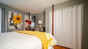 A bedroom with a four-poster bed, a large window, and a wardrobe. - Newly Remodeled 1-BR Close to Everything yet Very Private (Wallingford)
