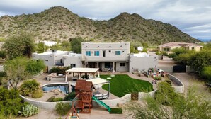 A modern two-story house with a pool, patio, and a mountain backdrop. - A D O B E  -  E S T A T E (Mesa)